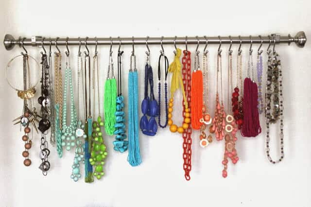 Curtain rail on the wall with hooks for necklaces